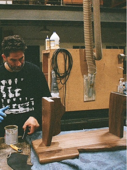 Finishing a wooden piece in the studio